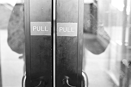 Door with two pull signs